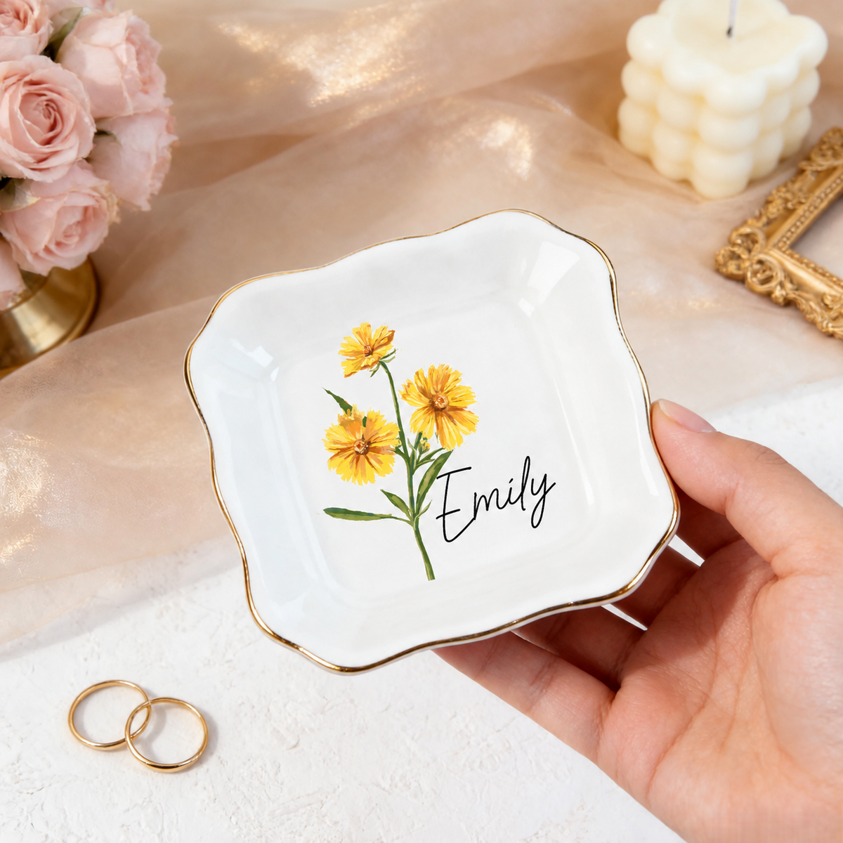 Hand holding a personalized wavy birth flower ring dish