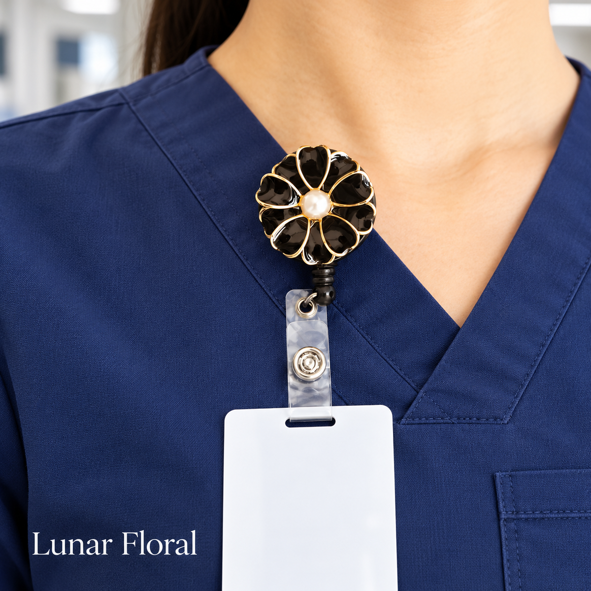 Black floral badge reel worn on navy medical scrubs